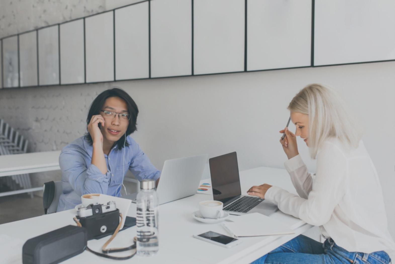 Instructor reviewing financial model on laptop with student